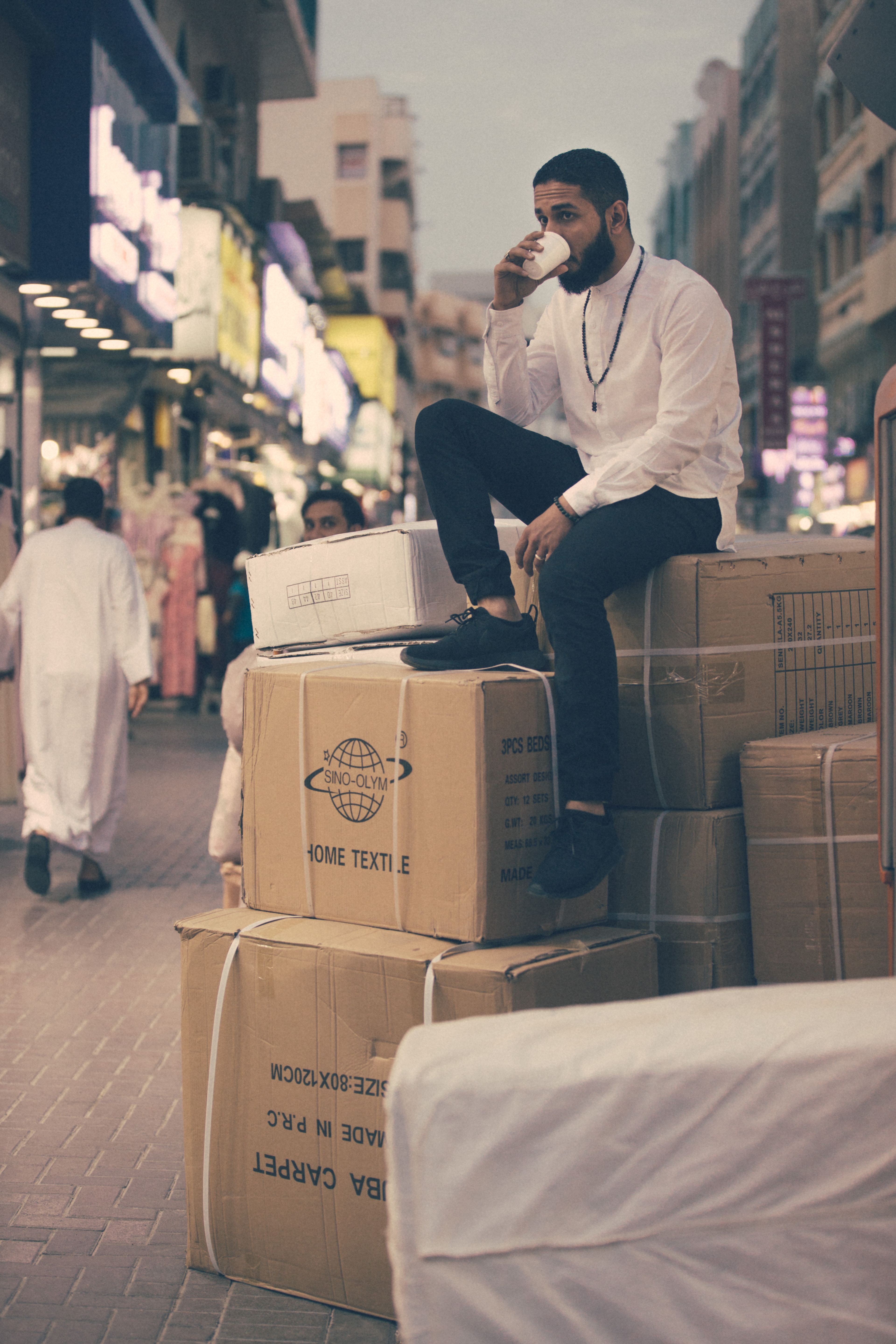 Man sitting on some boxes.