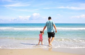 Father and daughter on a beach.