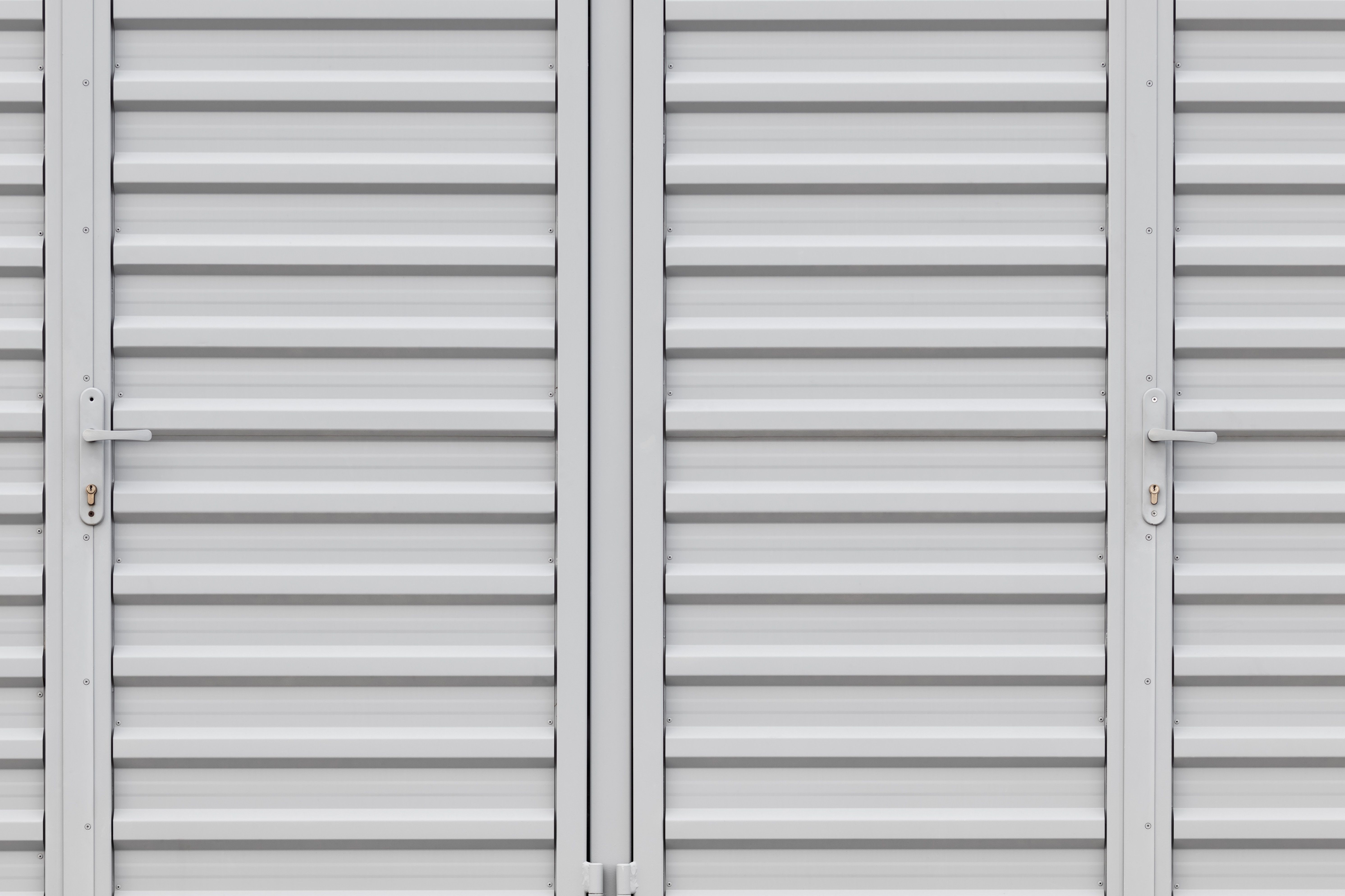 The doors of a white storage unit.