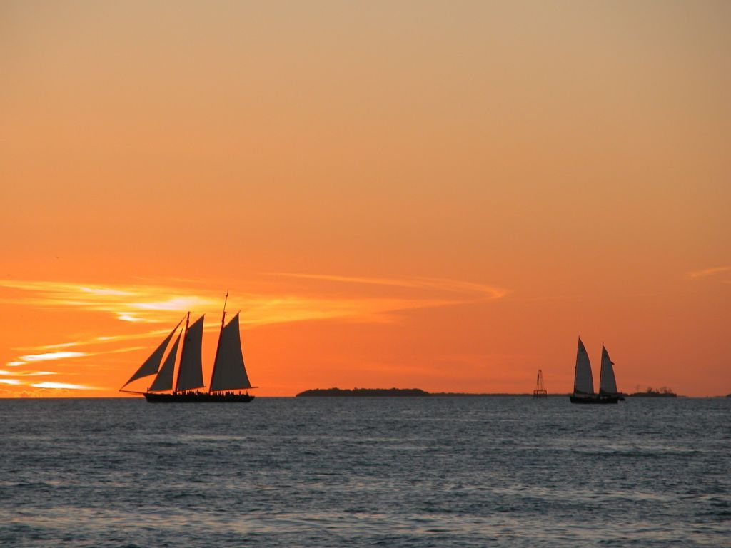 Several ships on the sea during the sunset