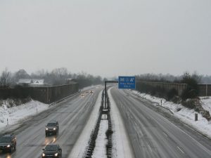 A highway in the winter, clear of snow, representing moving in winter.