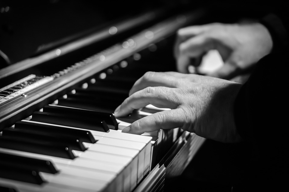 A close up of someone playing a piano.