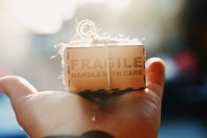 Box with fragile items on a hand