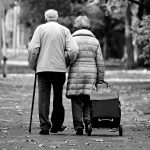 An elderly couple walking down the street.