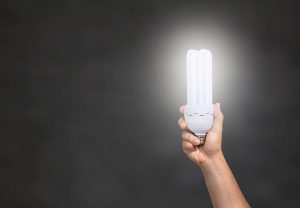 a hand holding a LED light bulb