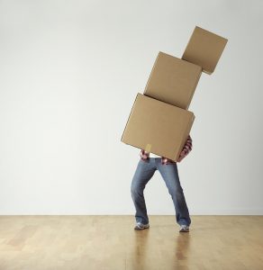 a man carrying three boxes by himself