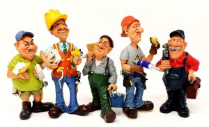 avoid a renovation nightmare by choosing professional contractors. Five figures of craftsmen standing with their equipment