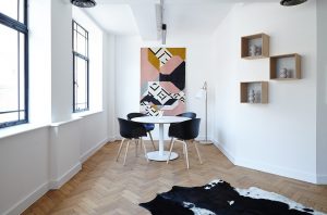 a dining room with a table and black chair around it