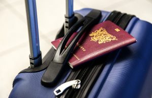 A blue suitcase and a passport